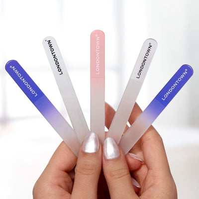 A pair of hands holding five Glass Nail Files - Petal (Professional) with different gradients and "LONDONTOWN" printed on each of them ensures effortless nail filing.