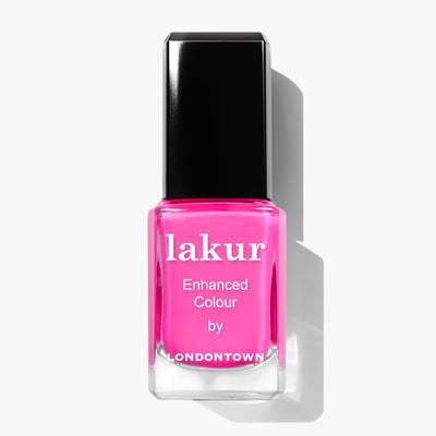 A bottle of LONDONTOWN Berry Punch (Professional) nail polish in a vibrant hot pink shade with "Enhanced Colour" text on the front. Made in the USA, this vegan, cruelty-free polish features a sleek black cap.