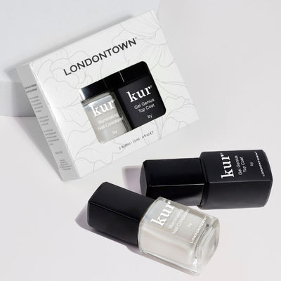 LONDONTOWN presents the Conceal + Go Duo, featuring their Illuminating Nail Concealer and Gel Genius Top Coat for naturally flawless nails, with a branded box gracefully displayed in the background.