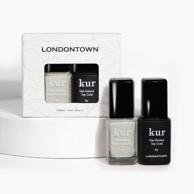 The LONDONTOWN Conceal + Go Duo features two nail polish bottles, one white and one black, elegantly showcased in front of their packaging to promise naturally perfect nails.