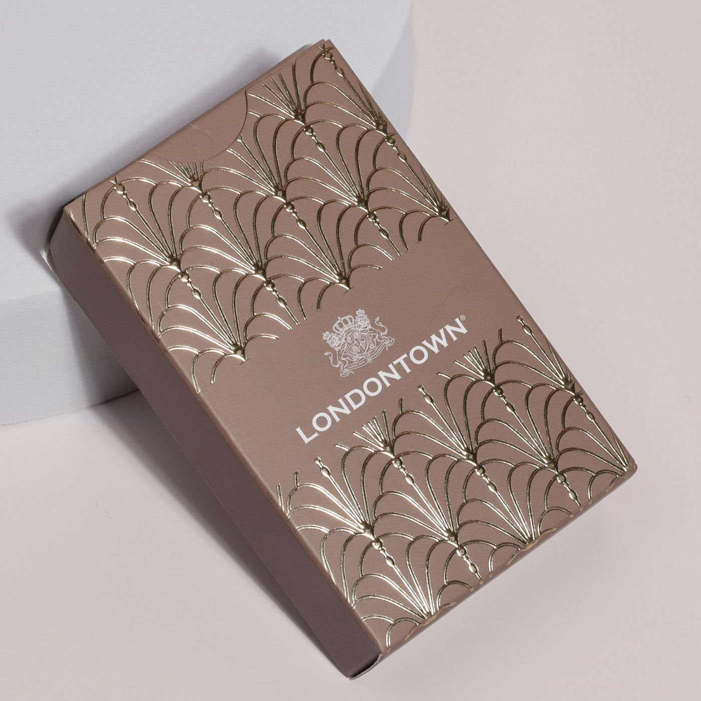 A set of Parlour Party Playing Cards, encased in a brown box adorned with gold and silver embossed decorative patterns and the text "LONDONTOWN," best enjoyed as an elegant addition to any collection.