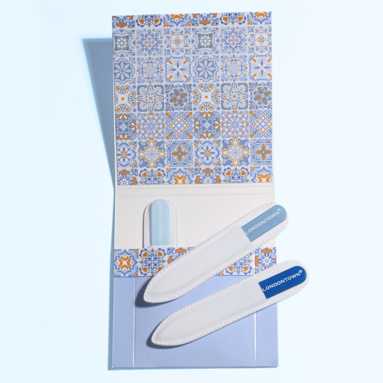 The "Mini Nail File Set" by LONDONTOWN includes two nail files in a stylish blue and orange patterned pouch, perfect for keeping your nails filed on the go.