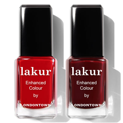 Two bottles from the Cozy Fireside Duo by LONDONTOWN; one features a vibrant deep red crème, while the other showcases rich burgundy—ideal for seasonal nails.