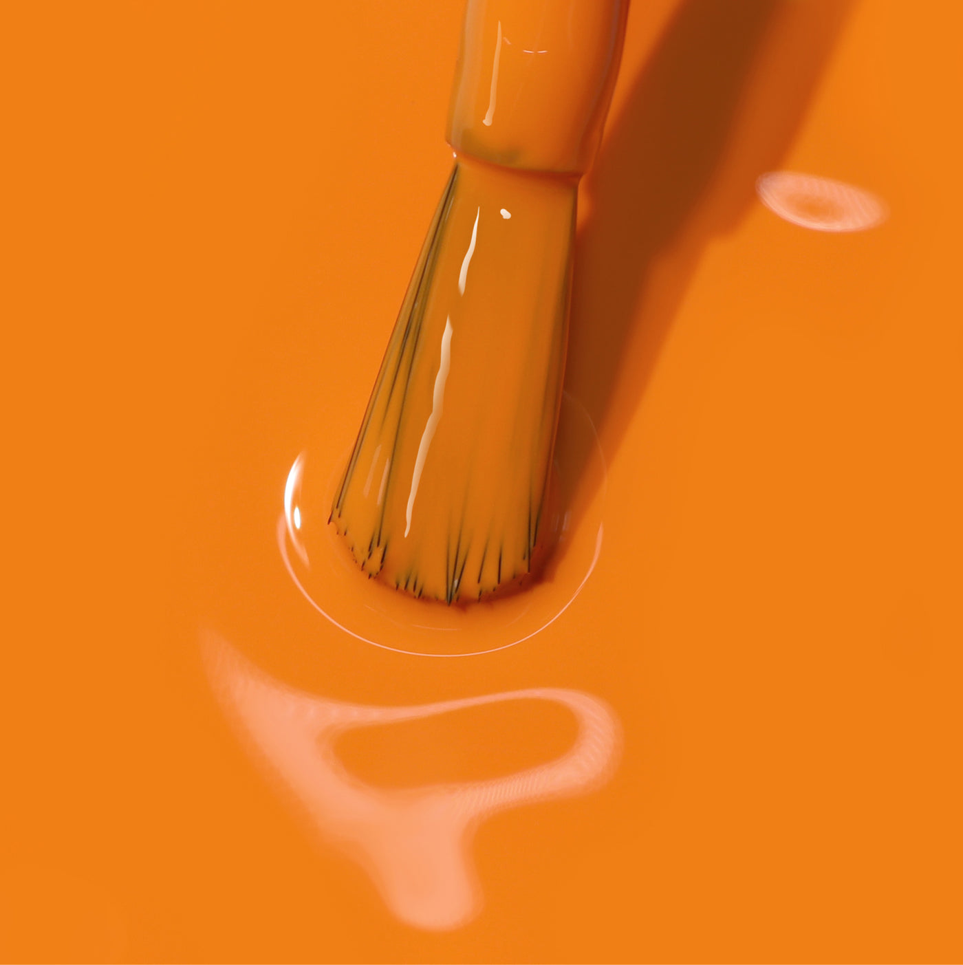 A paintbrush with LONDONTOWN's Heat Wave (Professional) paint on its bristles is dipped into a smooth, shiny orange surface.