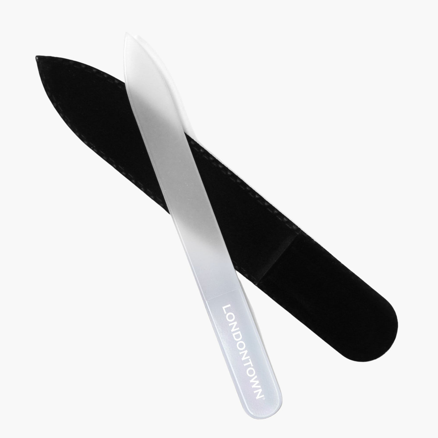 Effortlessly achieve damage-free nail filing with the "Glass Nail File - Milky" by LONDONTOWN, elegantly placed at an angle atop a black protective sleeve.