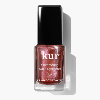 Clear glass bottle of LONDONTOWN's Shimmering Nail Highlighter - Molten with a black cap, containing pink, glittery nail polish. This product's shimmering shield catches light beautifully, adding an enchanting sparkle to your nails.