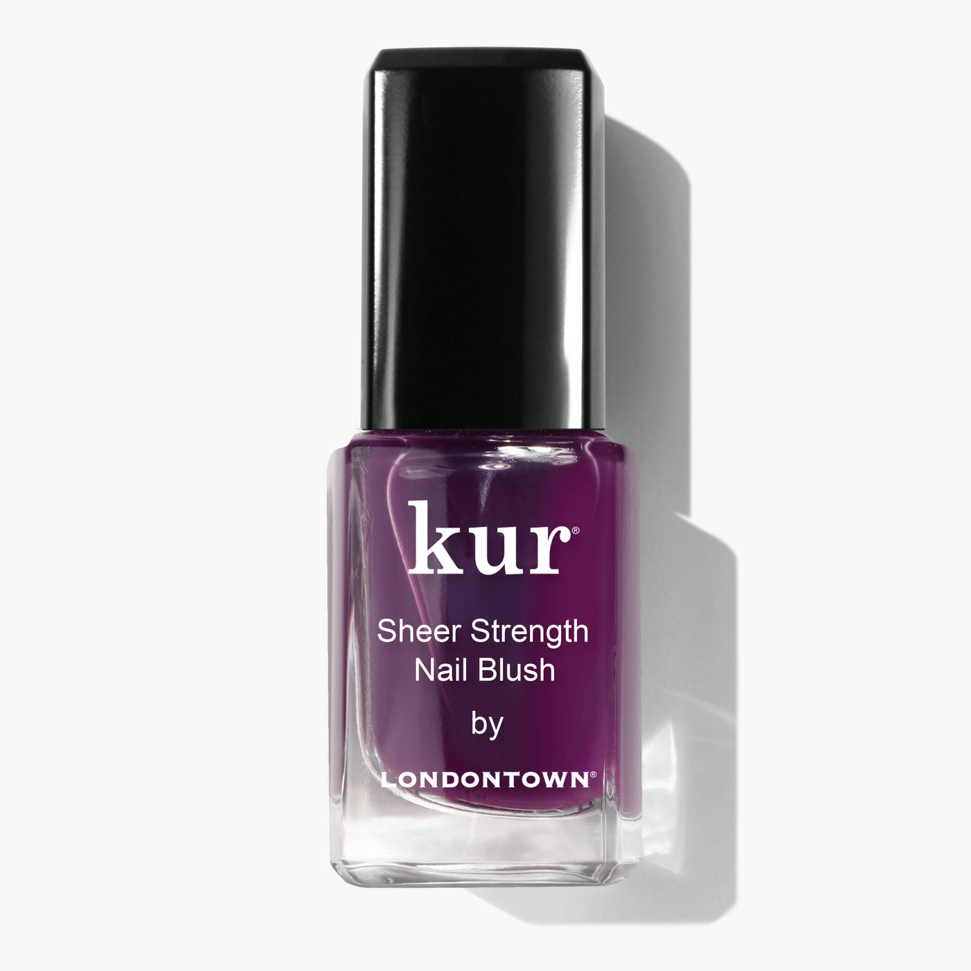 A bottle of LONDONTOWN's "Sheer Strength Nail Blush - Concord," a 2-in-1 nail hardener and polish in a dark purple shade, against a white background.