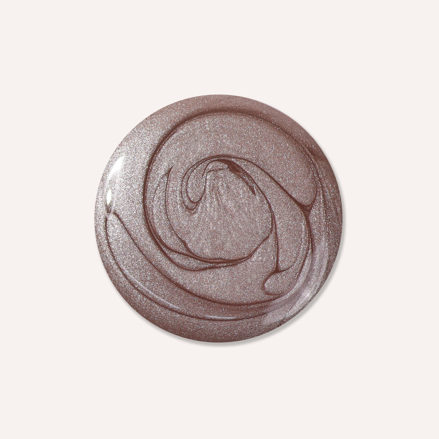 A circular dollop of LONDONTOWN's Nightcap gel, shimmering in antique bronze with swirling lighter and darker shades.