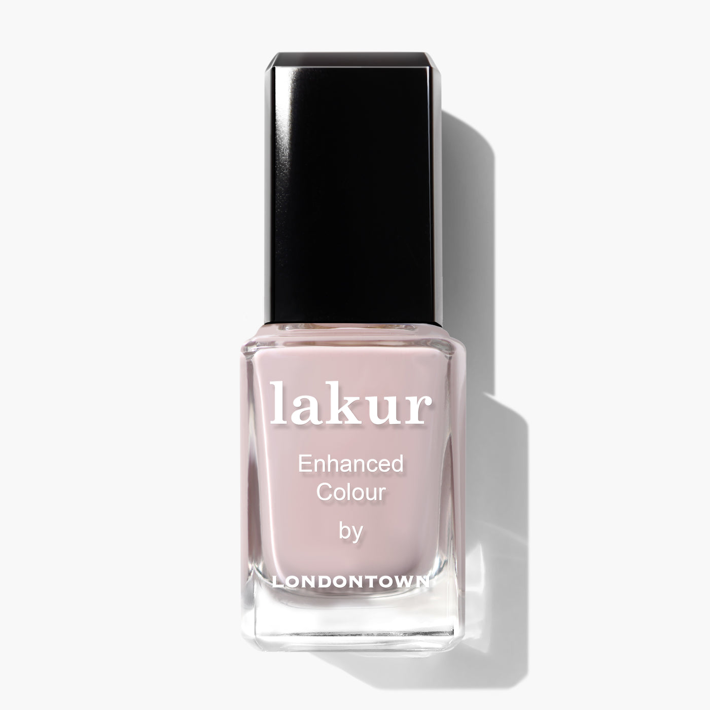 A bottle of LONDONTOWN’s Lakur Enhanced Colour nail polish in the shade Off the Record, which is a cool pastel light pink and comes with a black cap.