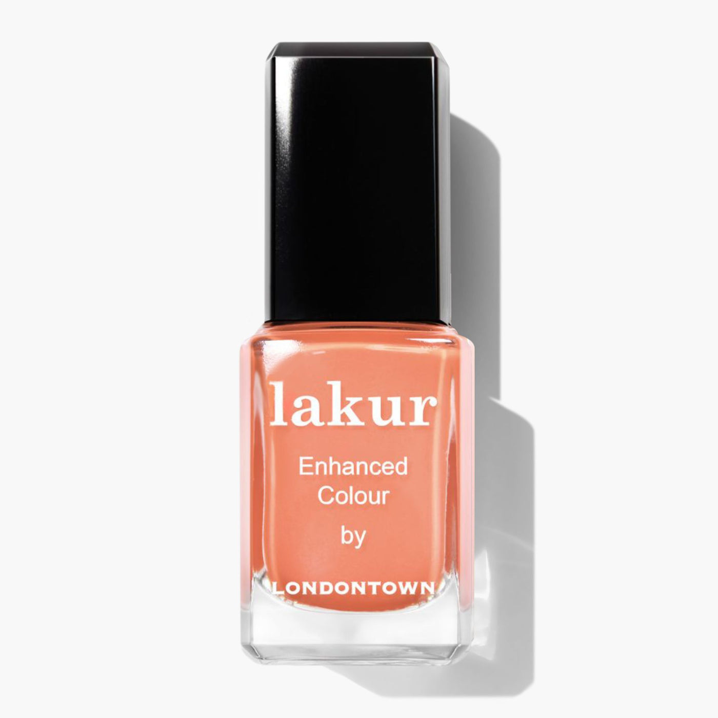 A rectangular bottle of LONDONTOWN's Lakur nail polish in the vibrant peach shade named Paloma. The label reads "lakur Enhanced Colour by LONDONTOWN," and it features a black cap.