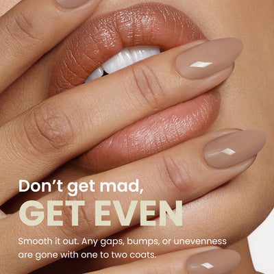 Close-up of a person with light brown, manicured nails touching their lips. Text reads: "Don’t get mad, GET EVEN. Smooth it out with LONDONTOWN's Fortifying Ridge Filler. Seamlessly smooths any ridges for a flawless finish with one to two coats.