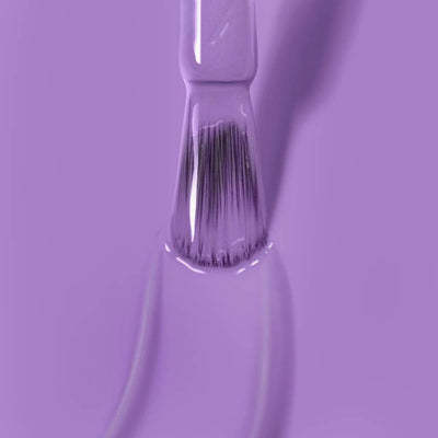 Close-up of a brush applying LONDONTOWN's Road Trip nail polish in psychedelic lavender.