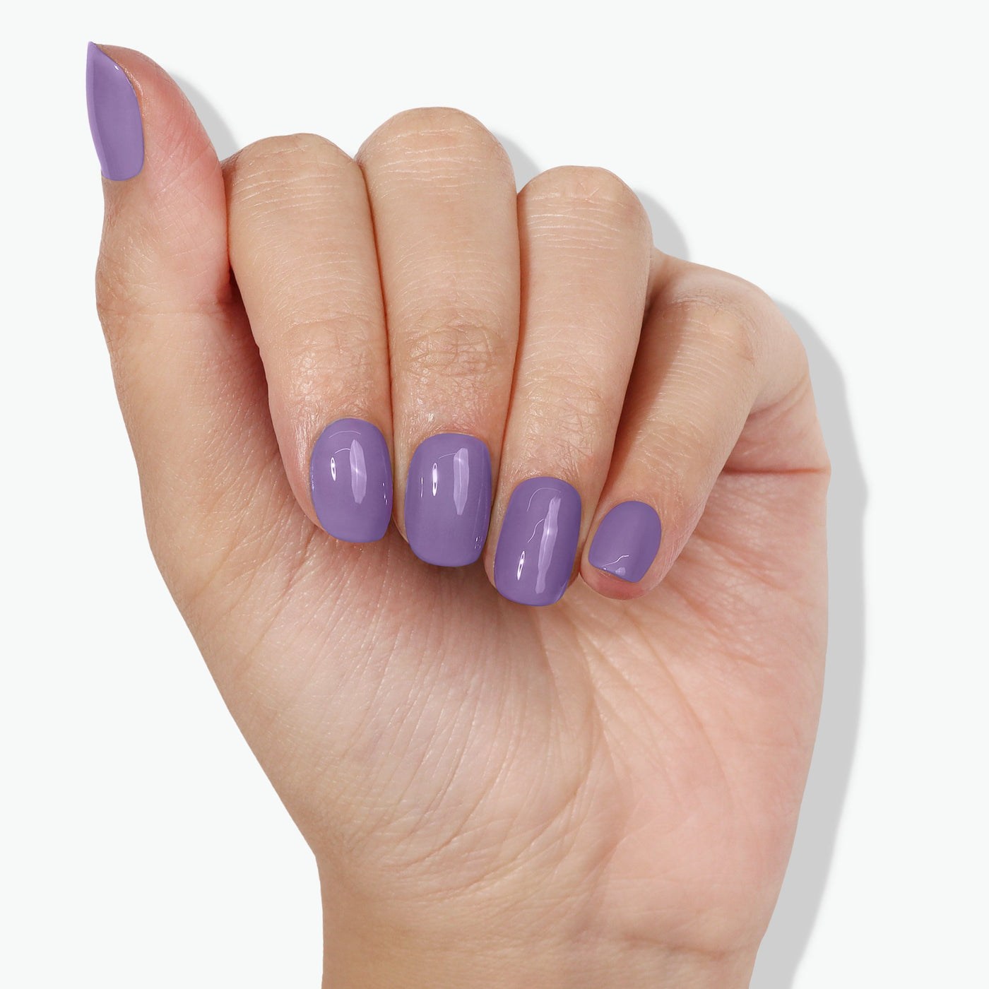 A hand with five fingers is shown, with nails painted in a smooth, glossy lavender purple color courtesy of "Road Trip" by LONDONTOWN, evoking a subtle, psychedelic vibe.