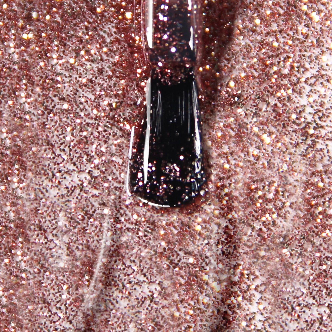 Close-up of a LONDONTOWN brush applying Rosé All Day glittery rose gold nail polish.