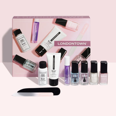 LONDONTOWN's Most-Loved & Must-Haves Set, your perfect wardrobe essential for the holiday season, includes nail polishes, treatments, and a file, all beautifully arranged in front of the product box.