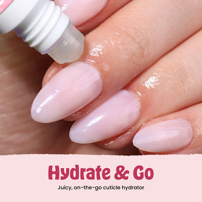 Close-up of manicured nails with a cuticle hydrator being applied. Text reads: "Hydrate & Go with LONDONTOWN's Juicy cuticle hydrator from our limited-edition Love & lakur Valentine’s Day Set.