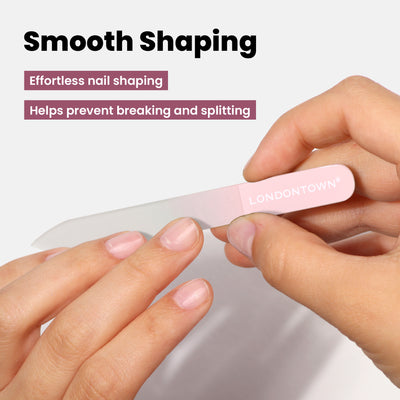 As part of their nail care routine, a person uses a pink nail file included in the "Most-Loved & Must-Haves Set" by LONDONTOWN. The product offers benefits such as "Effortless nail shaping" and "Helps prevent breaking and splitting," making it an ideal addition to your beauty regimen this holiday season.