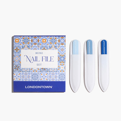 The LONDONTOWN Mini Nail File Set is perfect for on-the-go use. It includes three sleek white files in chic holders, all nestled beside a stylish blue and orange box, ensuring you're always filed up and ready in style.