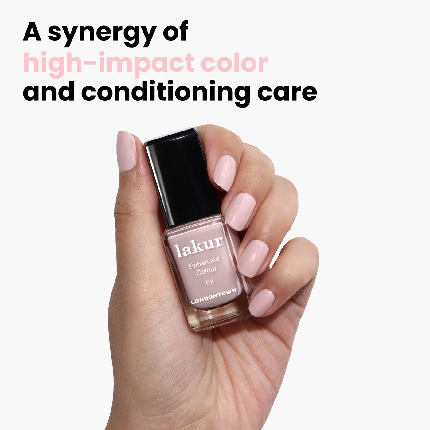 A hand holds a bottle of LONDONTOWN's Dream Scene opalescent pale pink nail polish against a white background, labeled "lakur," with the text: "A synergy of high-impact color and conditioning care.