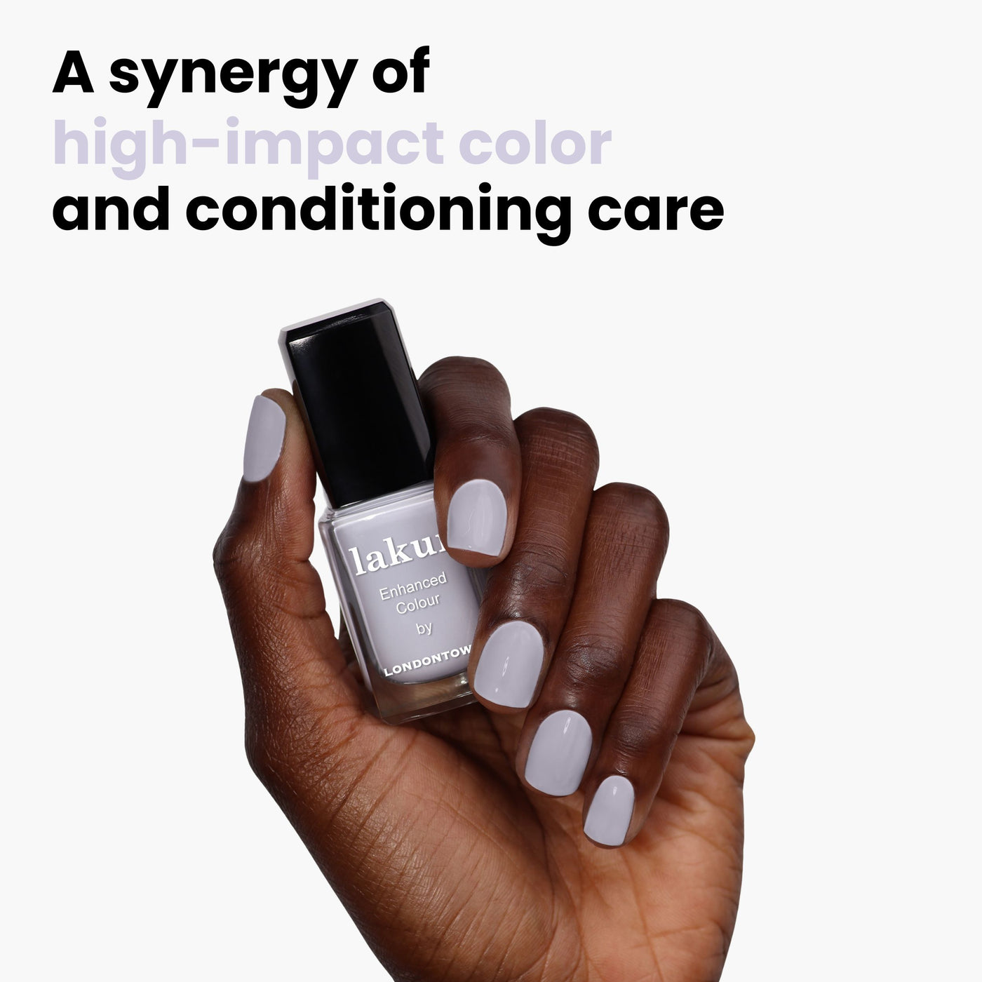 A hand holds a bottle of LONDONTOWN nail polish, nails painted in a matching Frostbitten hue. Text above reads, "A synergy of high-impact color and conditioning care.