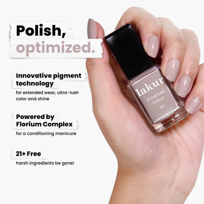 A hand holds a bottle of LONDONTOWN Beaumont nail polish, noted for its vegan, cruelty-free formula and Florium Complex. The polish is also devoid of 21+ harsh ingredients, offering a healthier manicure experience.