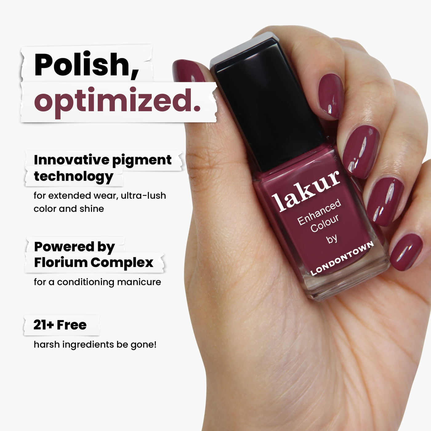 A hand holds a bottle of LONDONTOWN's Fig Jam nail polish, showcasing its captivating mauve-tinged purple. The formula uses innovative pigment technology and Florium Complex, offering a 21+ free formula that enriches your nails without harsh ingredients.