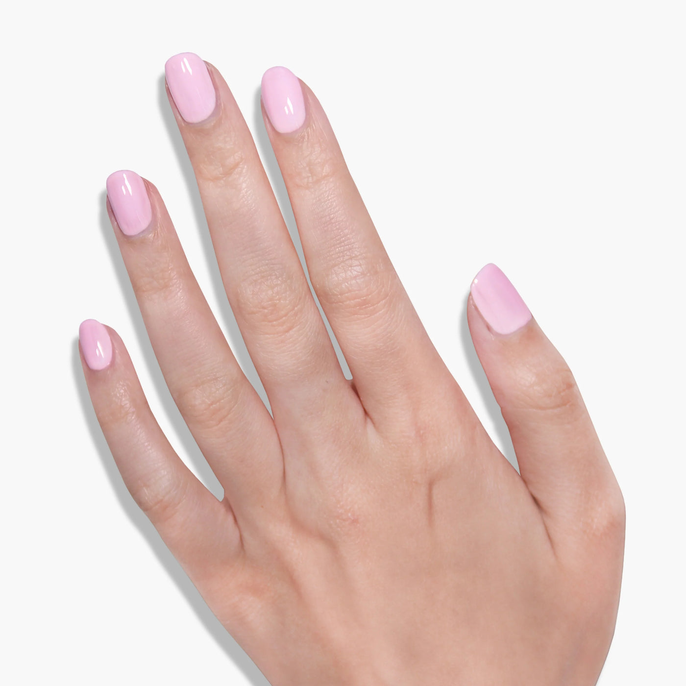 A hand with neatly manicured nails painted in the warm and cozy shade "Afternoon Tea (Professional)" by LONDONTOWN. The medium-length, rounded nails evoke the feeling of a relaxed afternoon sipping on a cup of tea.