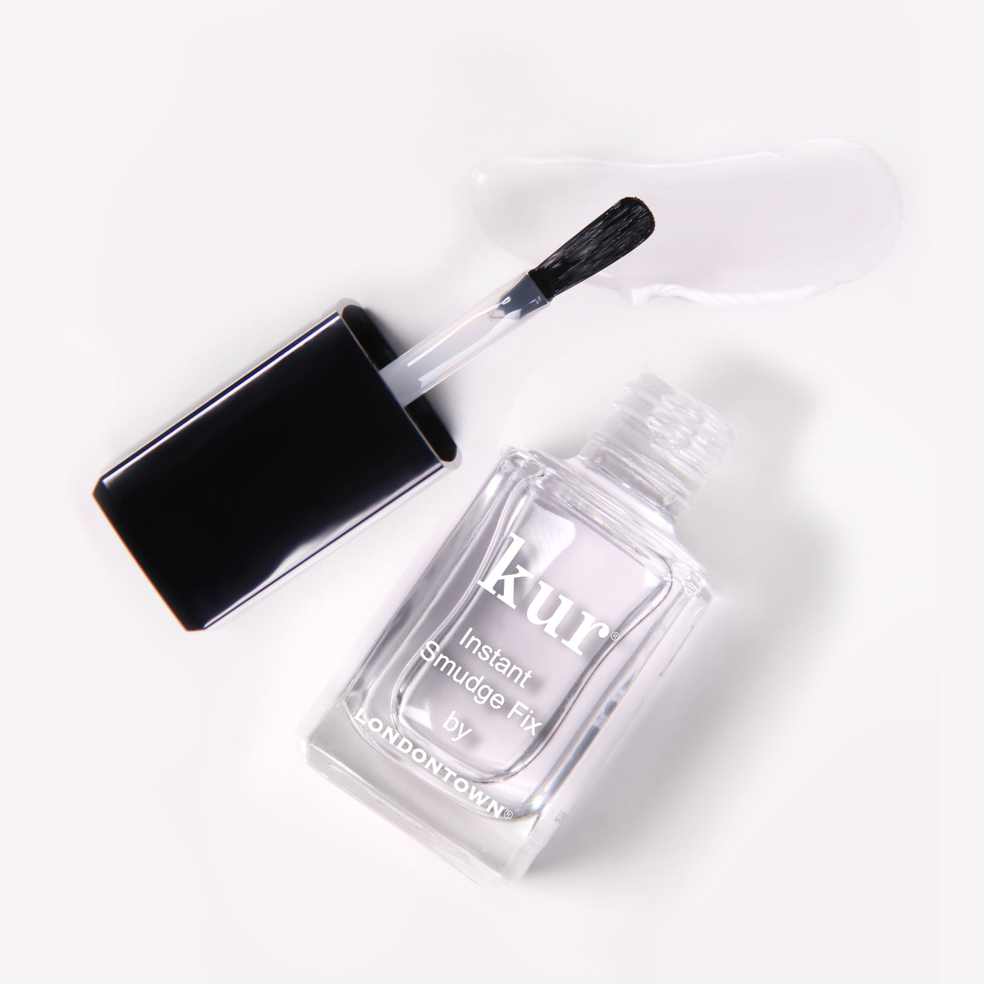 A bottle of LONDONTOWN Instant Smudge Fix (Professional) for nail polish repair, featuring a brush applicator and a small amount of clear liquid, showcased on a pristine white background. This vegan, cruelty-free solution ensures flawless nails with every use.